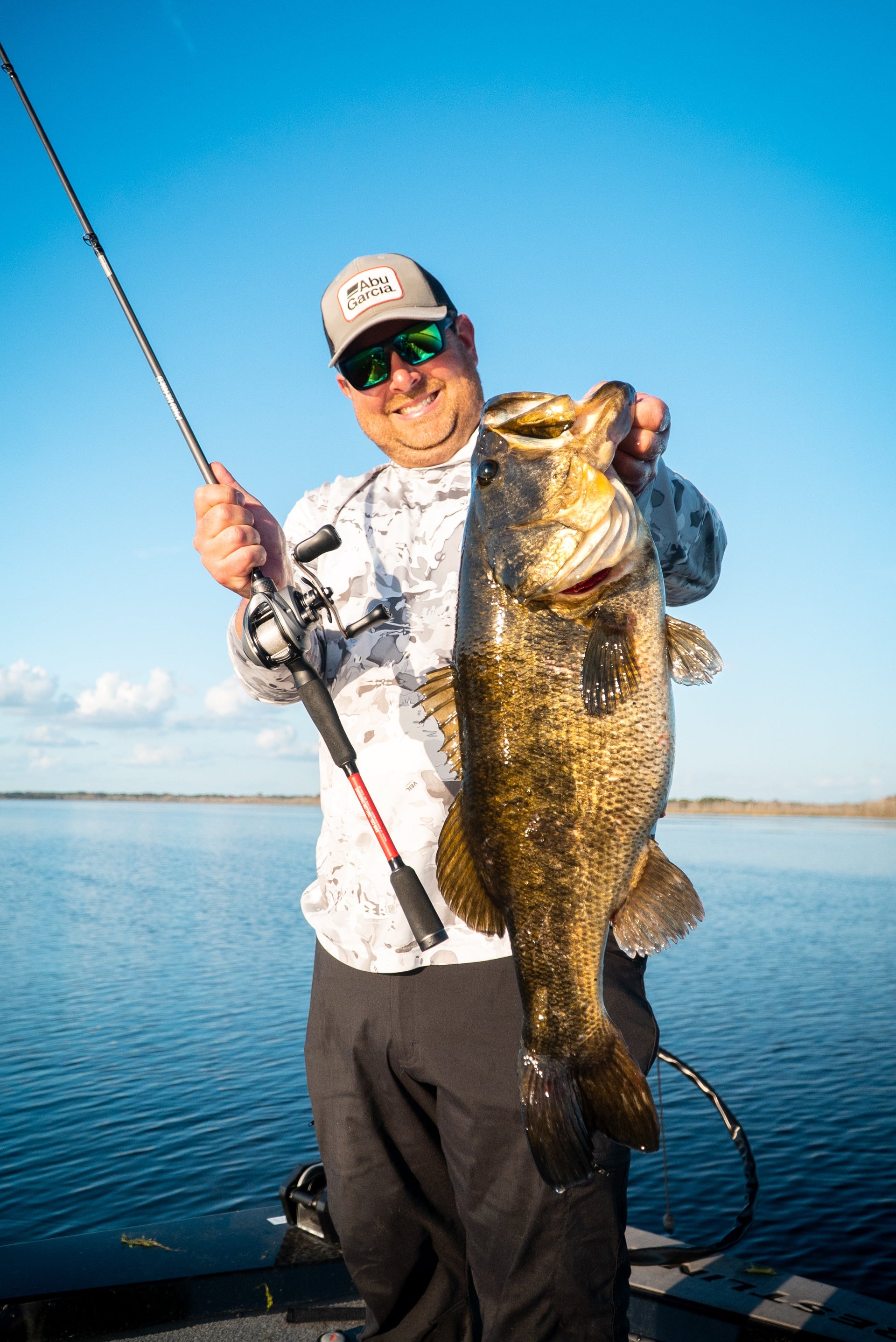 Man smiling and holding a large fish