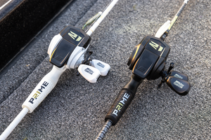 Two Abu Garcia + PRIME21 Collaboration Spincast Combos laying flat on pavement, one black & one white. 