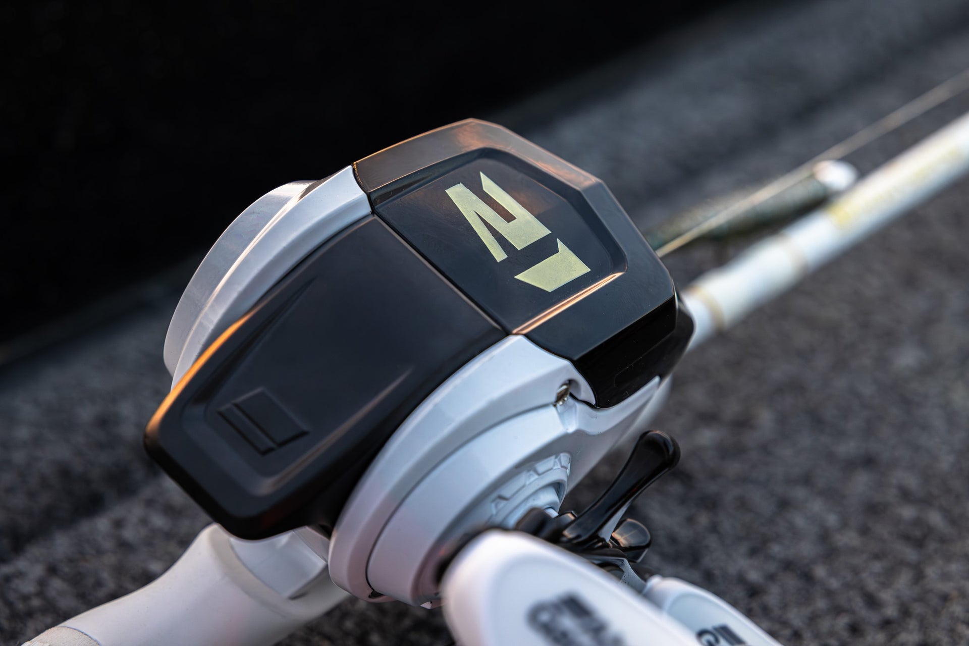 Close up of a Abu Garcia x PRIME21 Spincast Combo on a textured ground