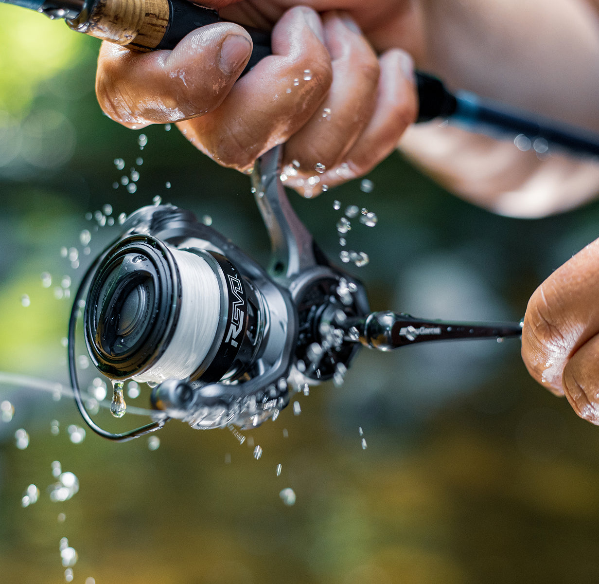 Revo Spinning Reel in a hand with water splashing and blurred background