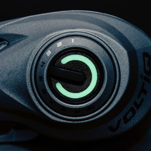 Close-up of a Revo® VoltiQ™ Low Profile Reel knob with a black background. 