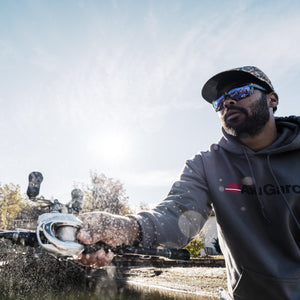 Man wearing Abu Garcia branded gear castsing a  Revo® VoltiQ™ Low Profile Reel over water.