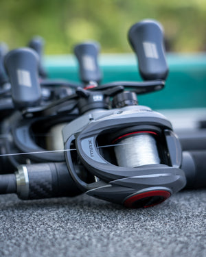 Close-up of a Abu Garcia Max Elite LP Reel on concrete with a blurred background. 