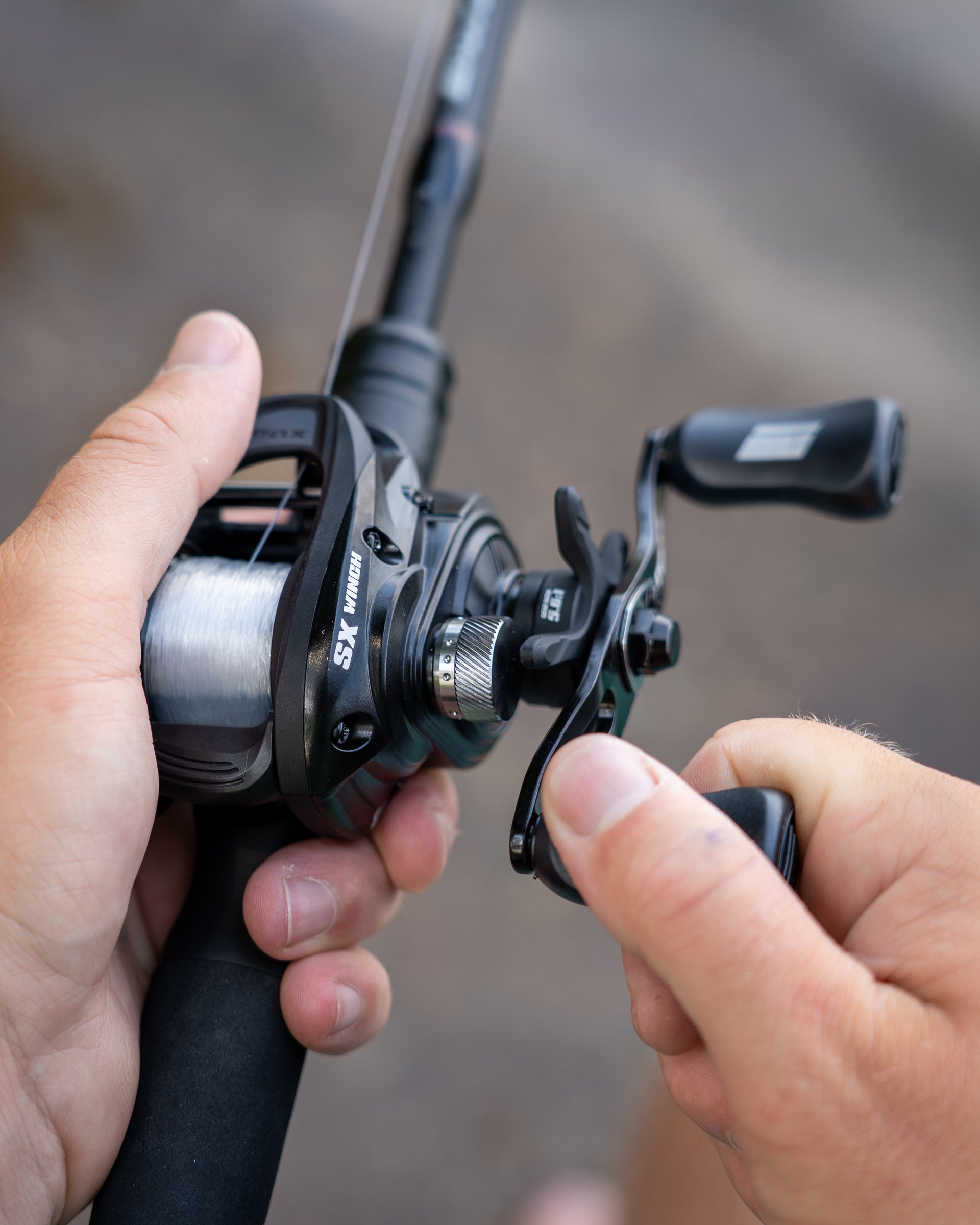 Close up of the Max™ SX Winch Low Profile Reel in someone's hand.