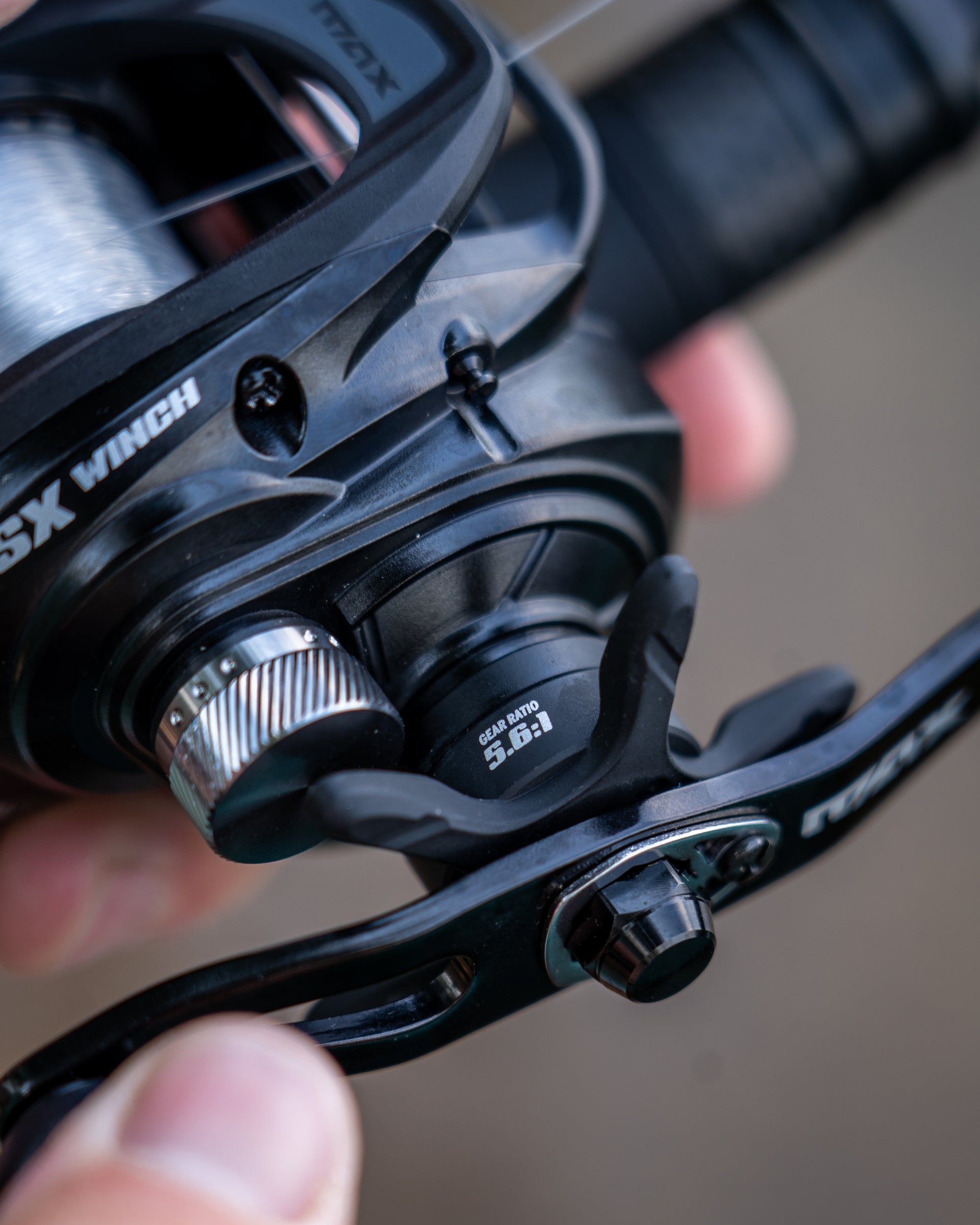 Close up of the Max™ SX Winch Low Profile Reel in someone's hand. 
