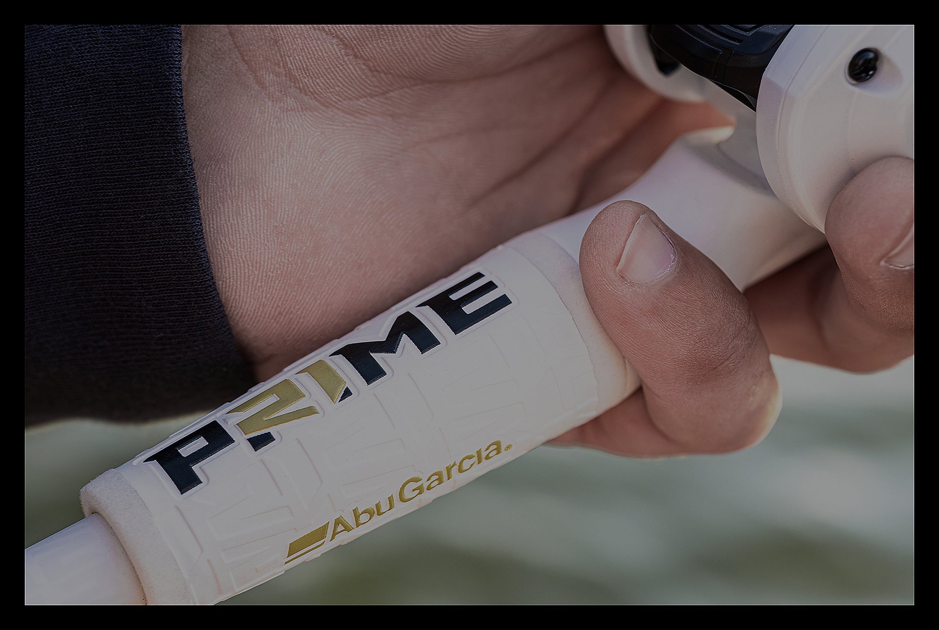 Hand holding a Abu Garcia Prime fishing rod handle
