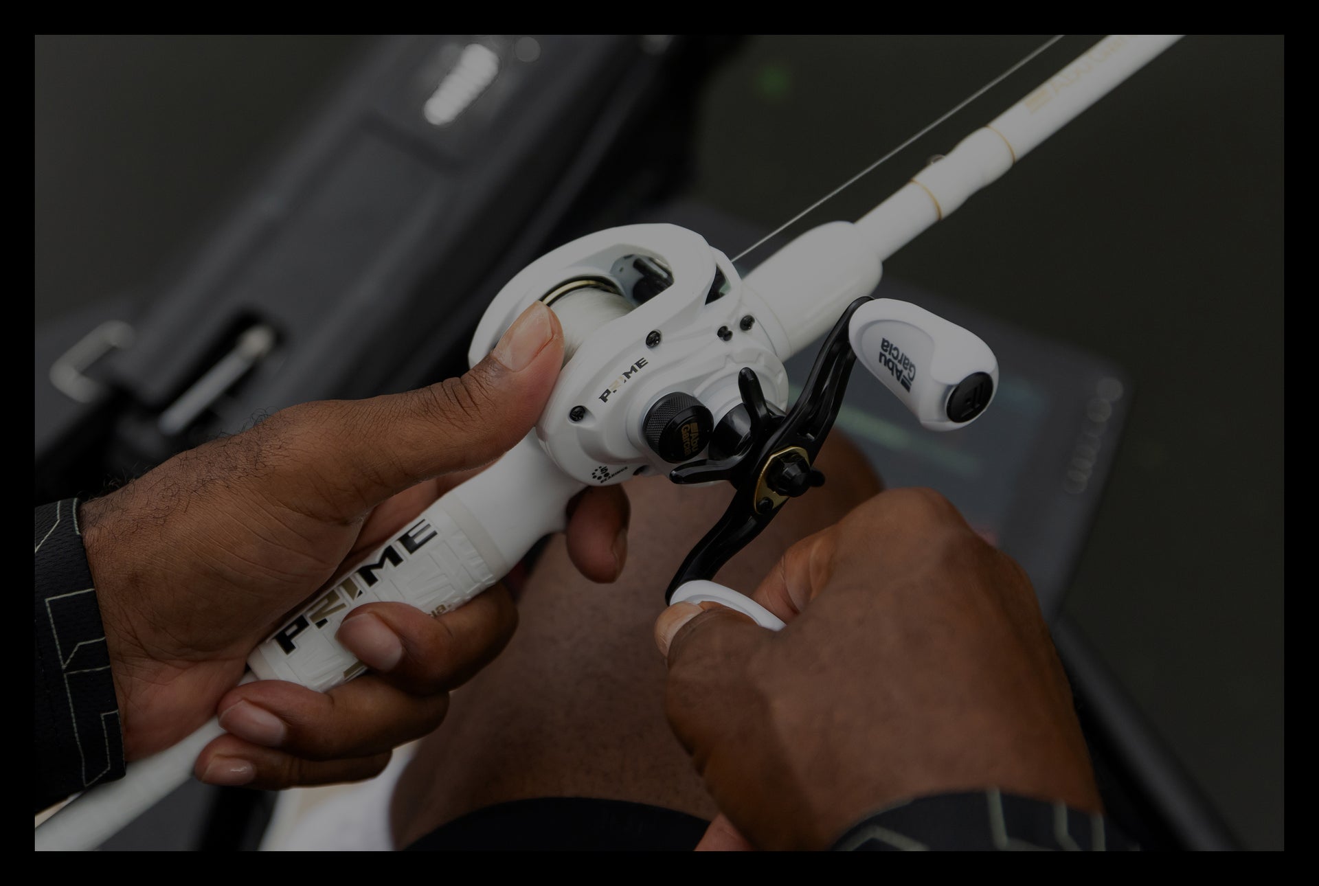 Close-up of hands holding a white fishing reel with a blurred background