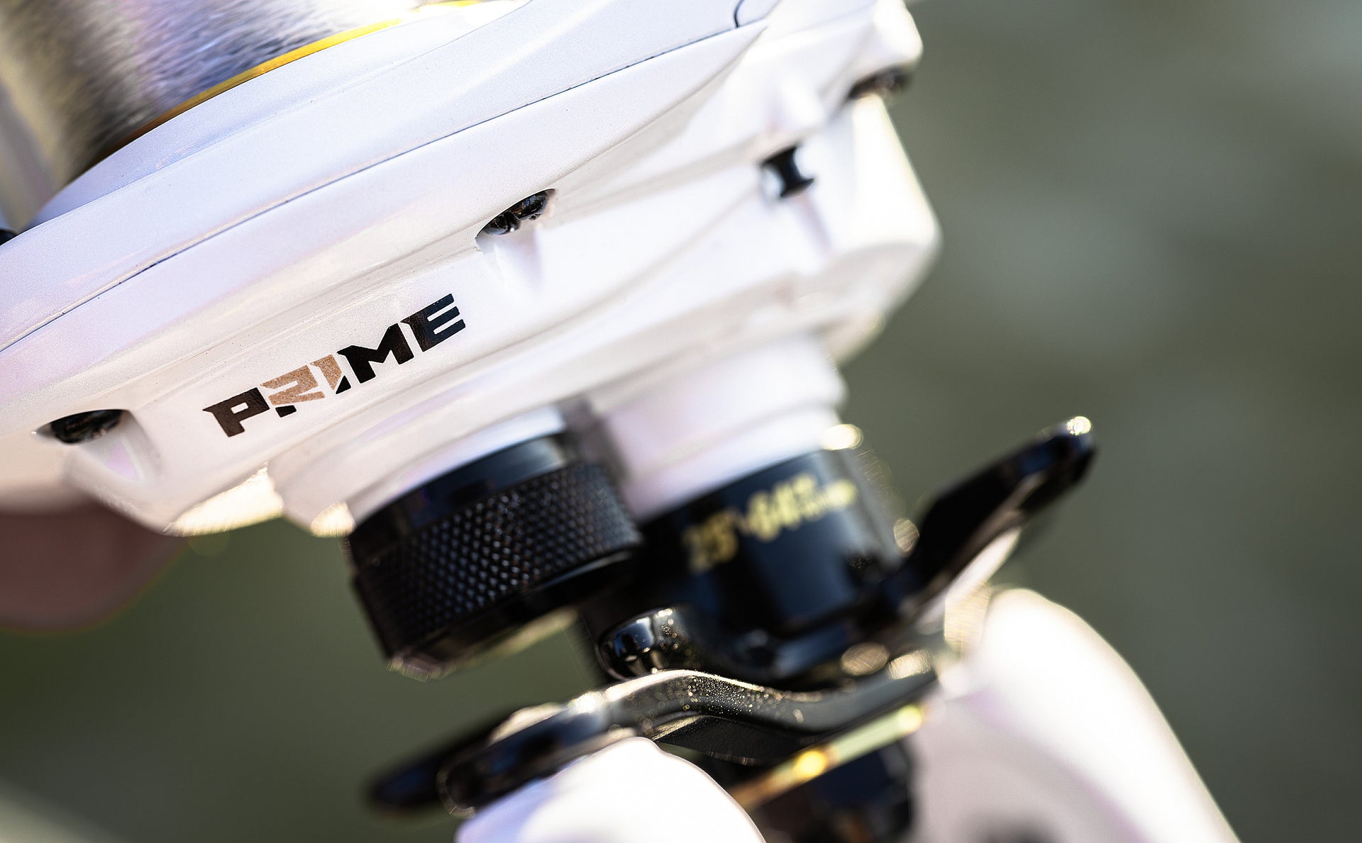 Close-up of a fishing reel with 'Prime' branding on a blurred background