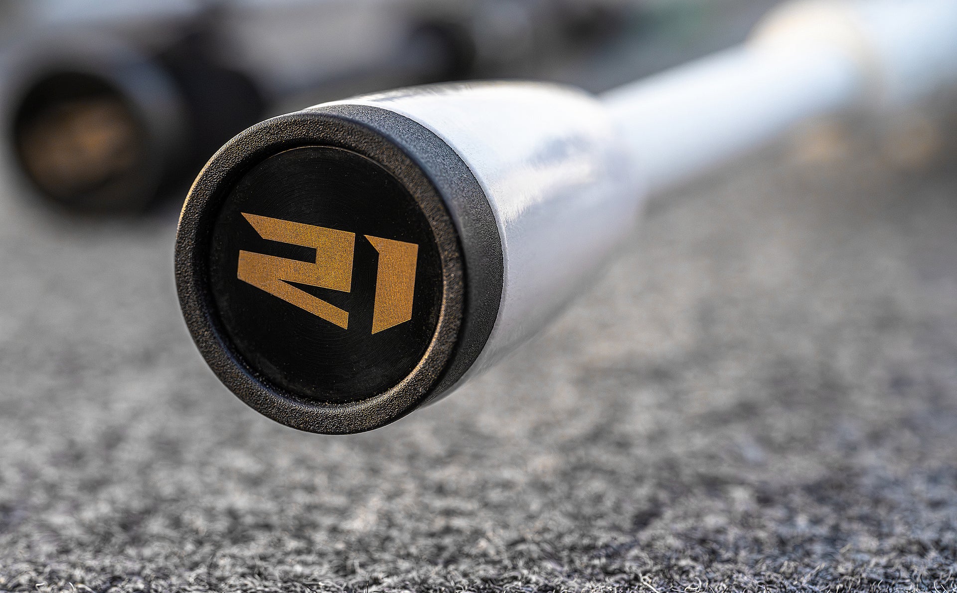 Close-up of a baseball bat handle with '21' branding on a textured surface.