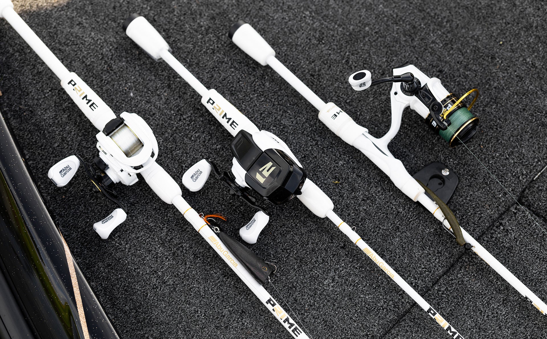Fishing rods and reels on a black surface