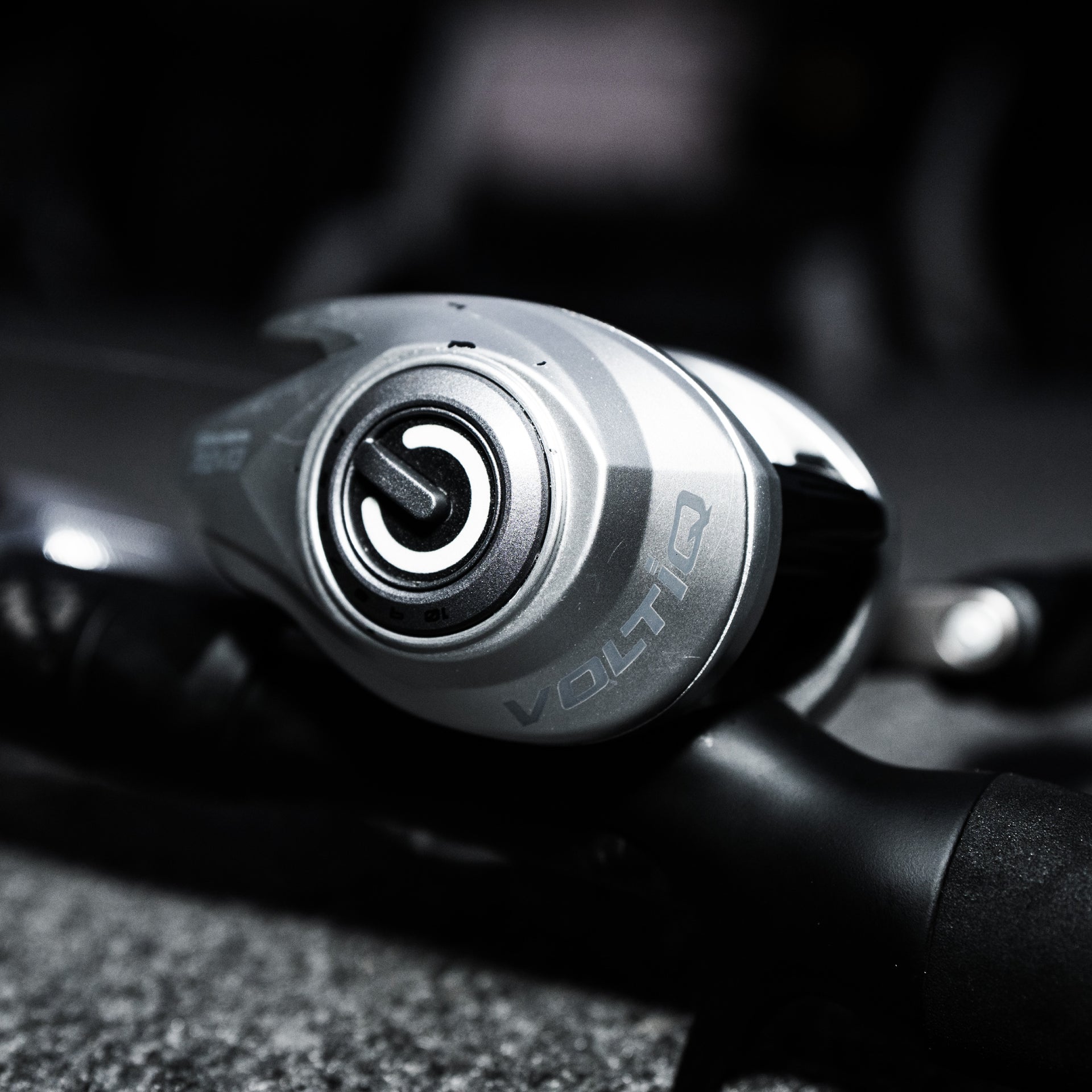 Close-up of a Volto fishing reel handle with blurred background