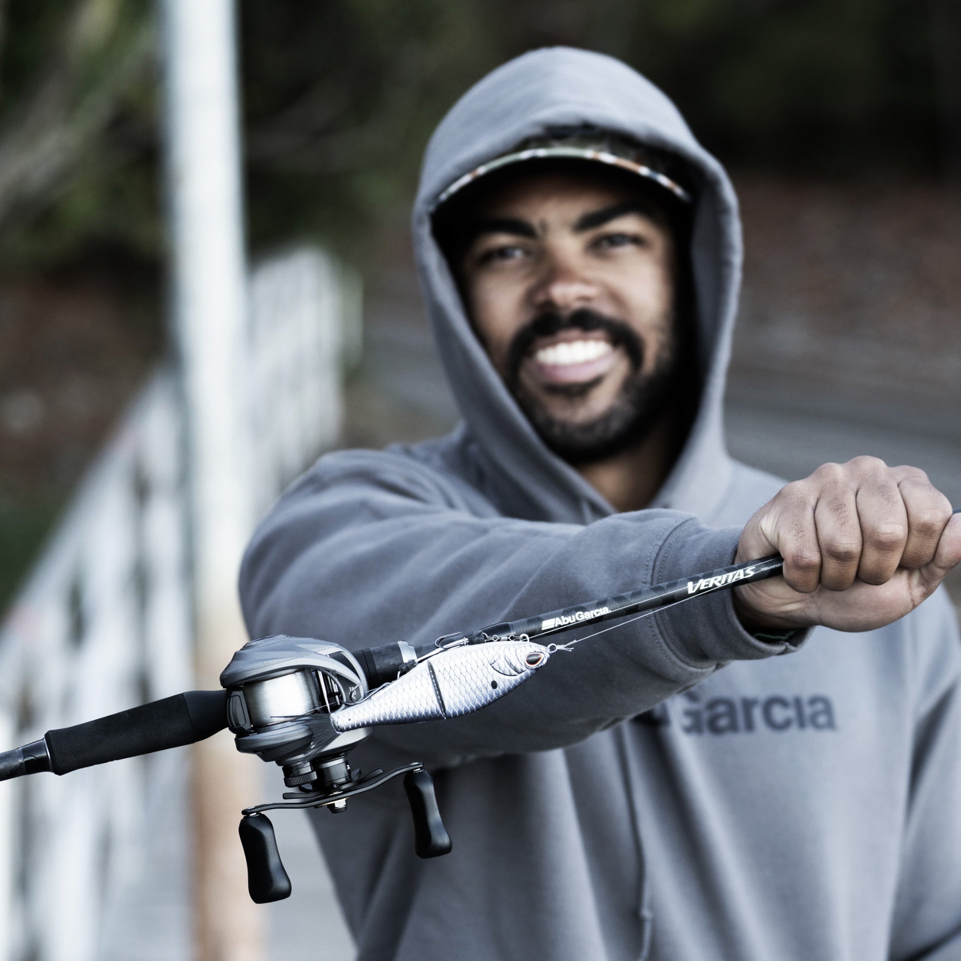Man holding a fishing rod with a blurred background
