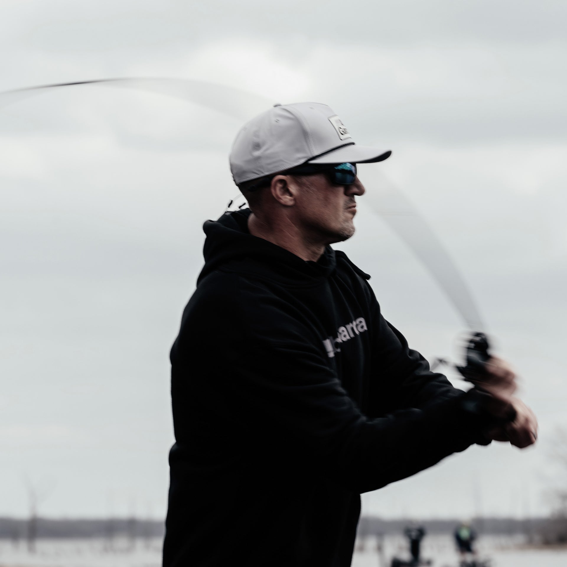 Man fishing on a boat with a blurred background