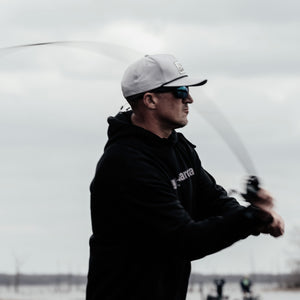Man fishing on a boat with a blurred background
