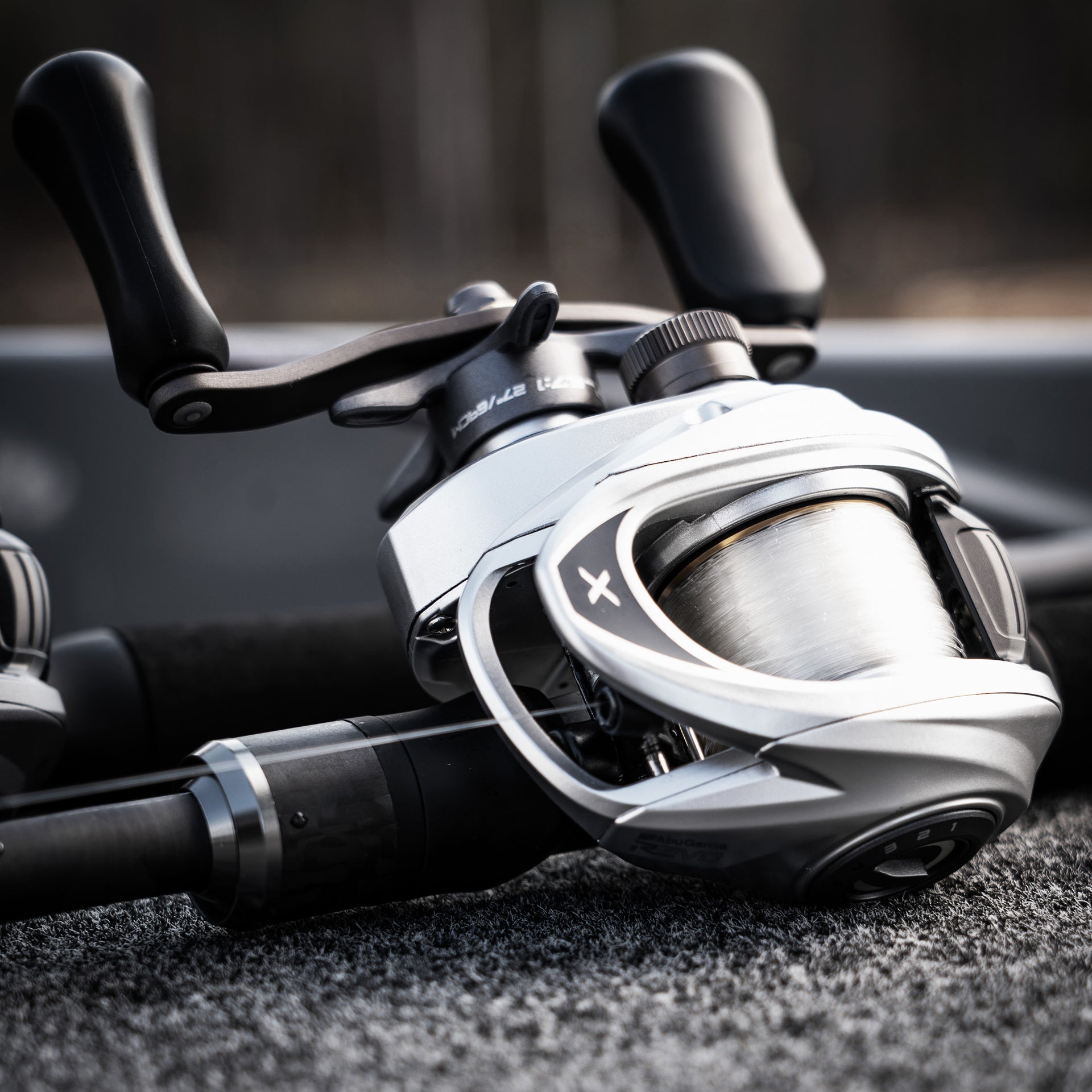 Close-up of a fishing reel with a blurred background