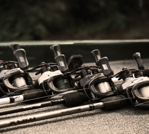 Fishing rods with reels on a surface, blurred background
