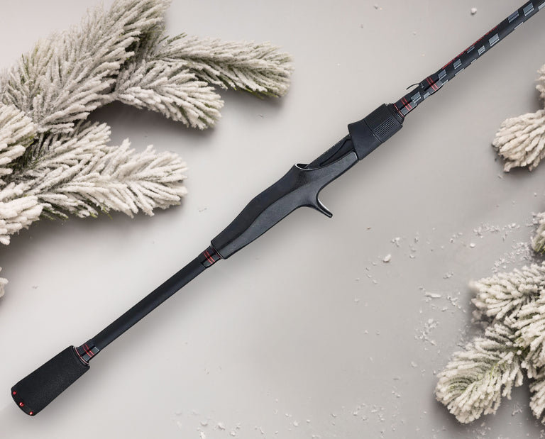 Abu Garcia Vendetta Rod on grey background with holiday snow covered pine